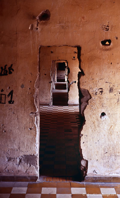 #10 Inside -21. Walls are broken open to interconnect former classrooms, now cells for up to 50 people or interrogation rooms.