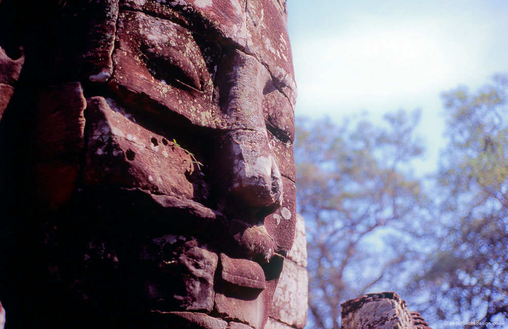 #26 Faces staring into the jungle. And at chinese tour buses. Bayon, Angkor.