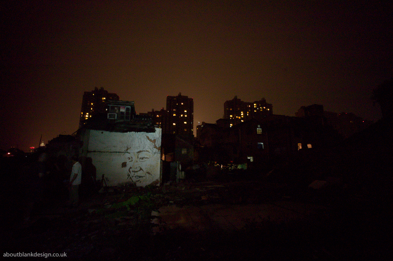 #21 Maraika found me and took me round a corner. Someone's painted a lady's face onto her own house's wall.