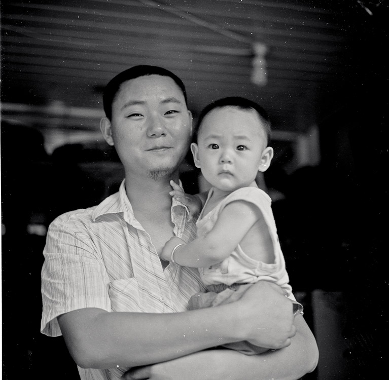 #12 We went on a bike ride and I got a rather flat tire. This dude and his kid posed for me while his wife fixed it.