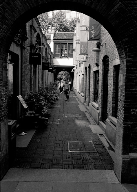 #13 On differences: This is Xintiandi, where the city government thought it would be good to preserve traditional Shanghai. In alleyways like this, where high class and extremely priced restaurants share the space with...
