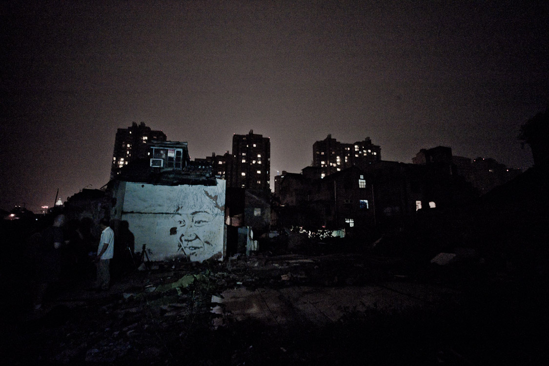 #44 Maraika found me and took me round a corner. Someone's painted a lady's face onto her own house's wall.